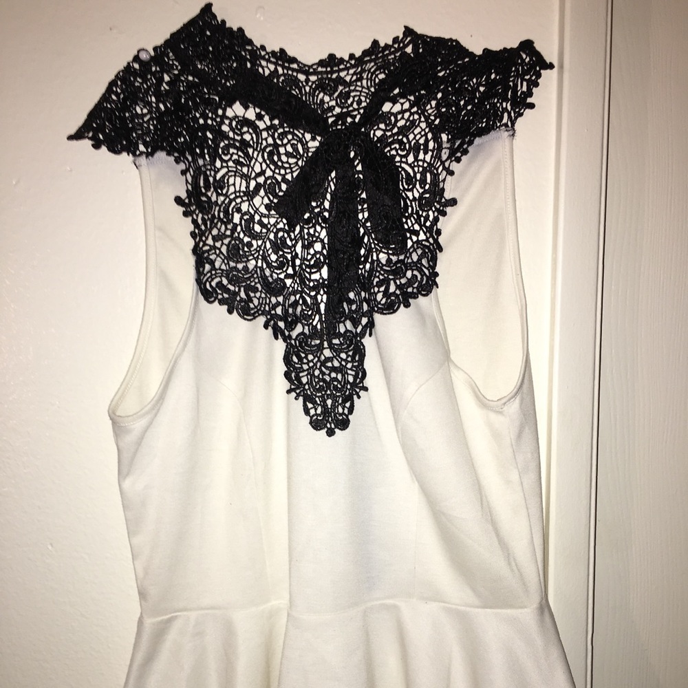 White peplum top with black  details
